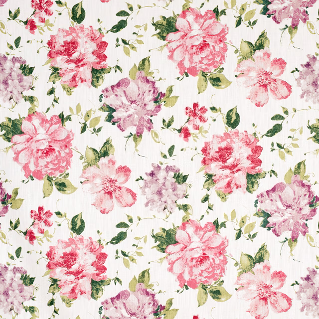 Pink and coral floral blooms with green leaves on an ivory textured fabric