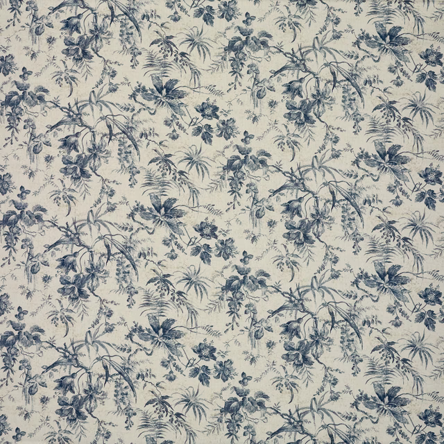 Cream fabric with dense blue-grey floral branches, palms and scattered botanical sprigs
