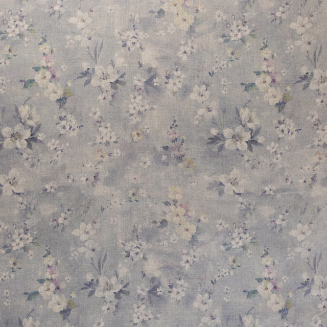 Cool blue-grey floral fabric with cream, lilac and dusty mauve scattered blooms