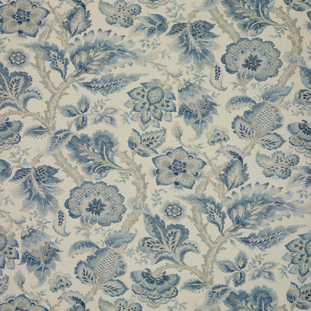 Muted blue floral sprays and rosettes on a warm ivory ground