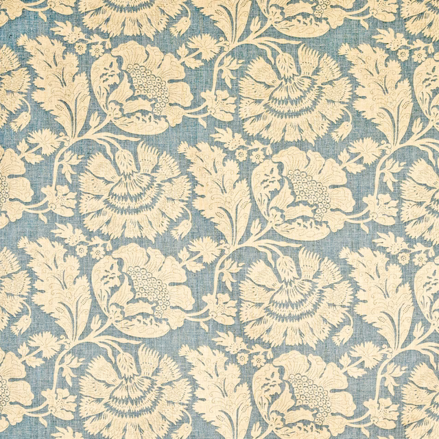 Muted blue-teal textile with cream birds, scrolling stems and large stylised flowers