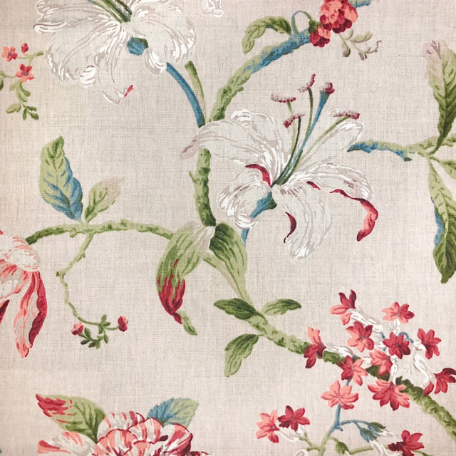 Natural woven ground with white lilies, red blossoms, blue leaves and green stems