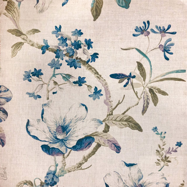 Cream woven ground with teal and blue blossoms, olive leaves and branching stems