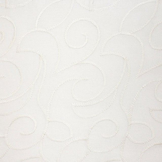 Ivory white fabric with raised scrolling embroidery and softly tactile stitching