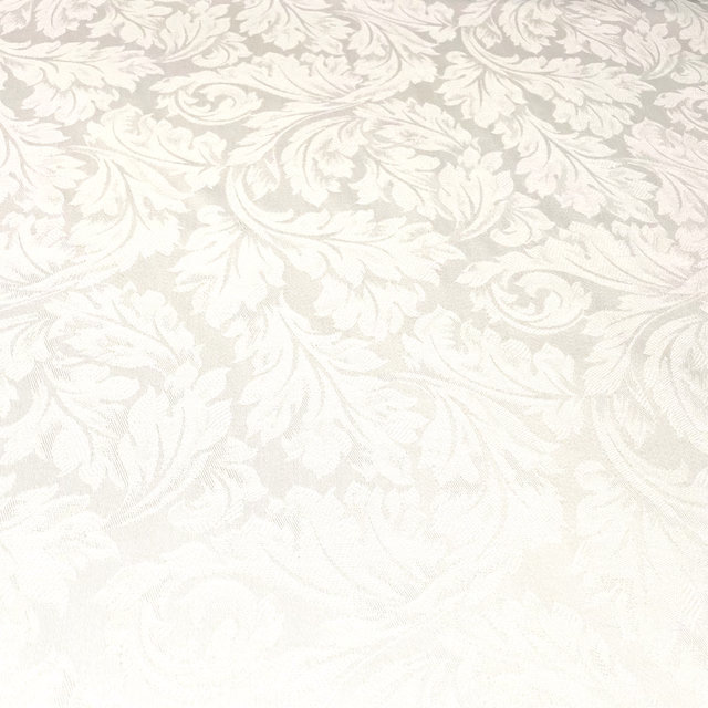 Soft off-white cotton damask with pale scrolling leaves and floral motifs