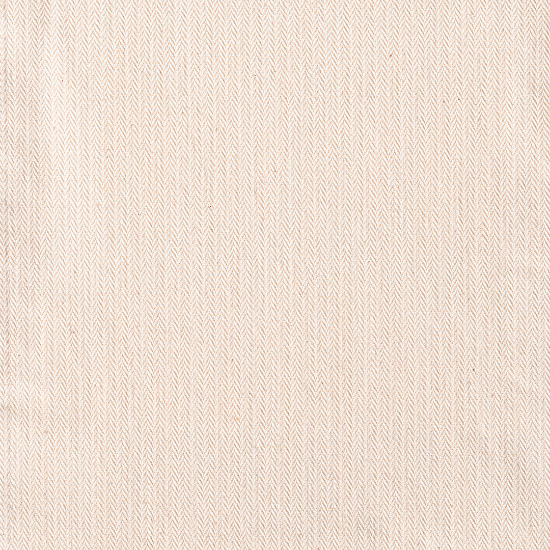 Warm ivory textile with delicate beige micro-chevron woven texture