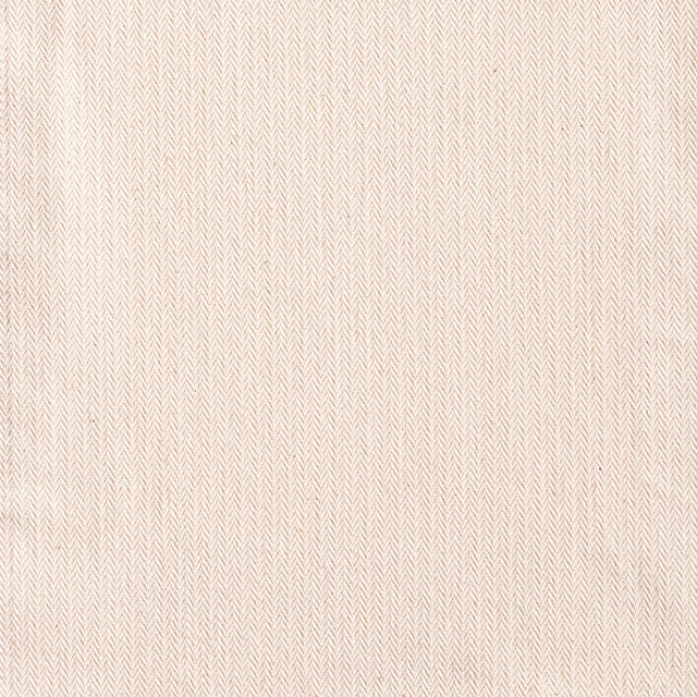 Warm ivory textile with delicate beige micro-chevron woven texture