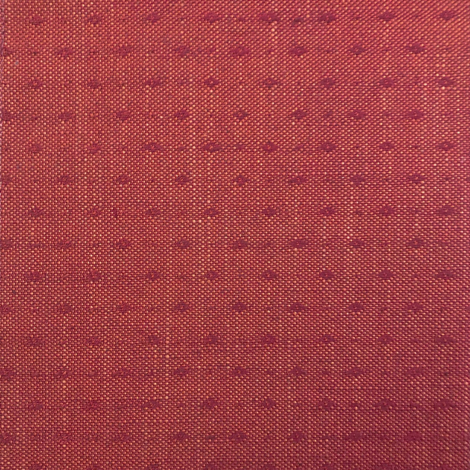 Muted brick-red woven ground with rows of tiny burgundy horizontal marks