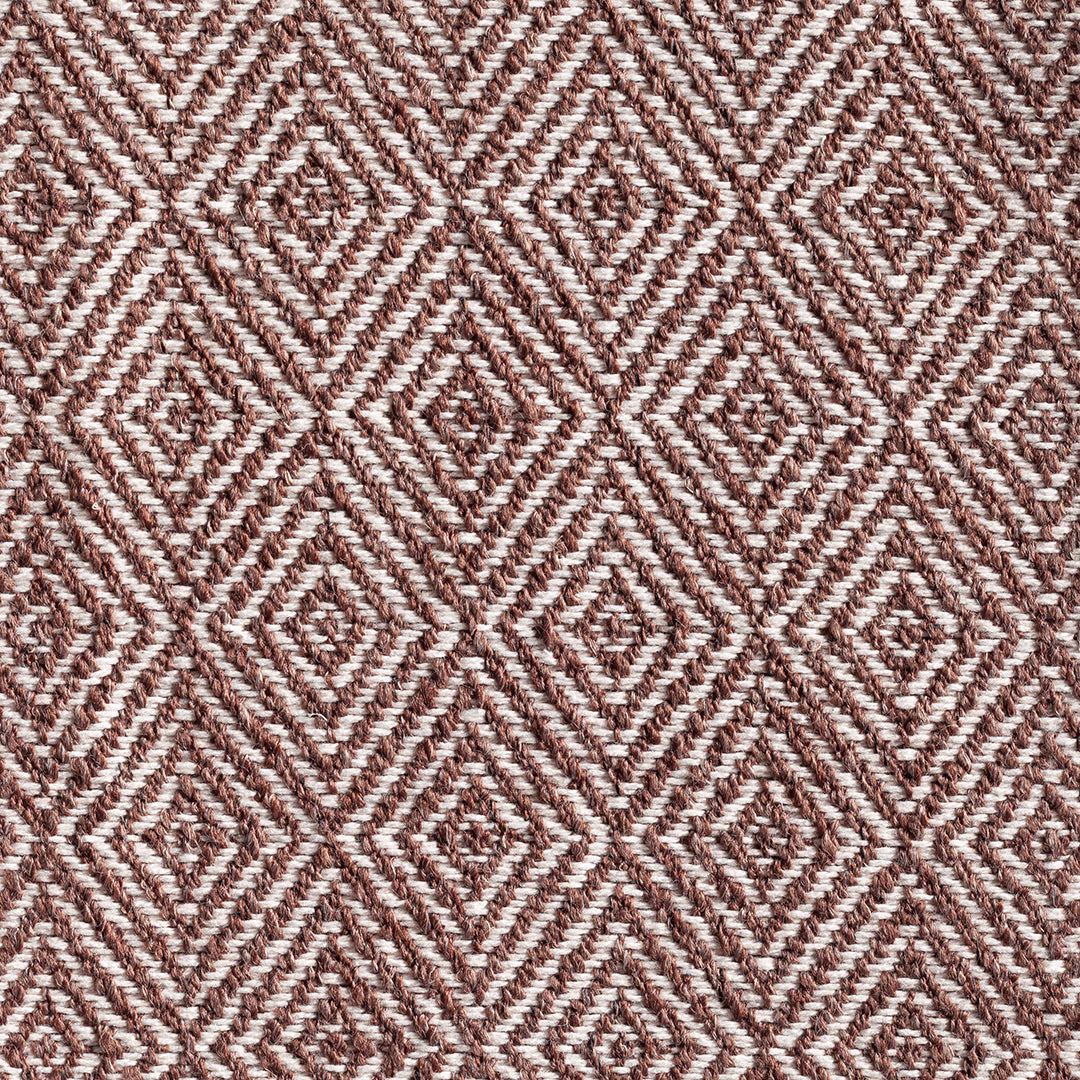 Warm bison-brown and ivory woven fabric with repeating diamond motifs and tactile ridges