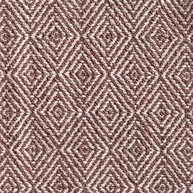 Warm bison-brown and ivory woven fabric with repeating diamond motifs and tactile ridges