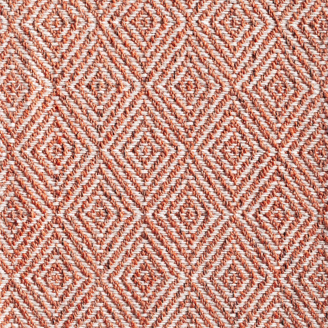 Warm chestnut and ivory woven textile with repeating concentric diamond motifs