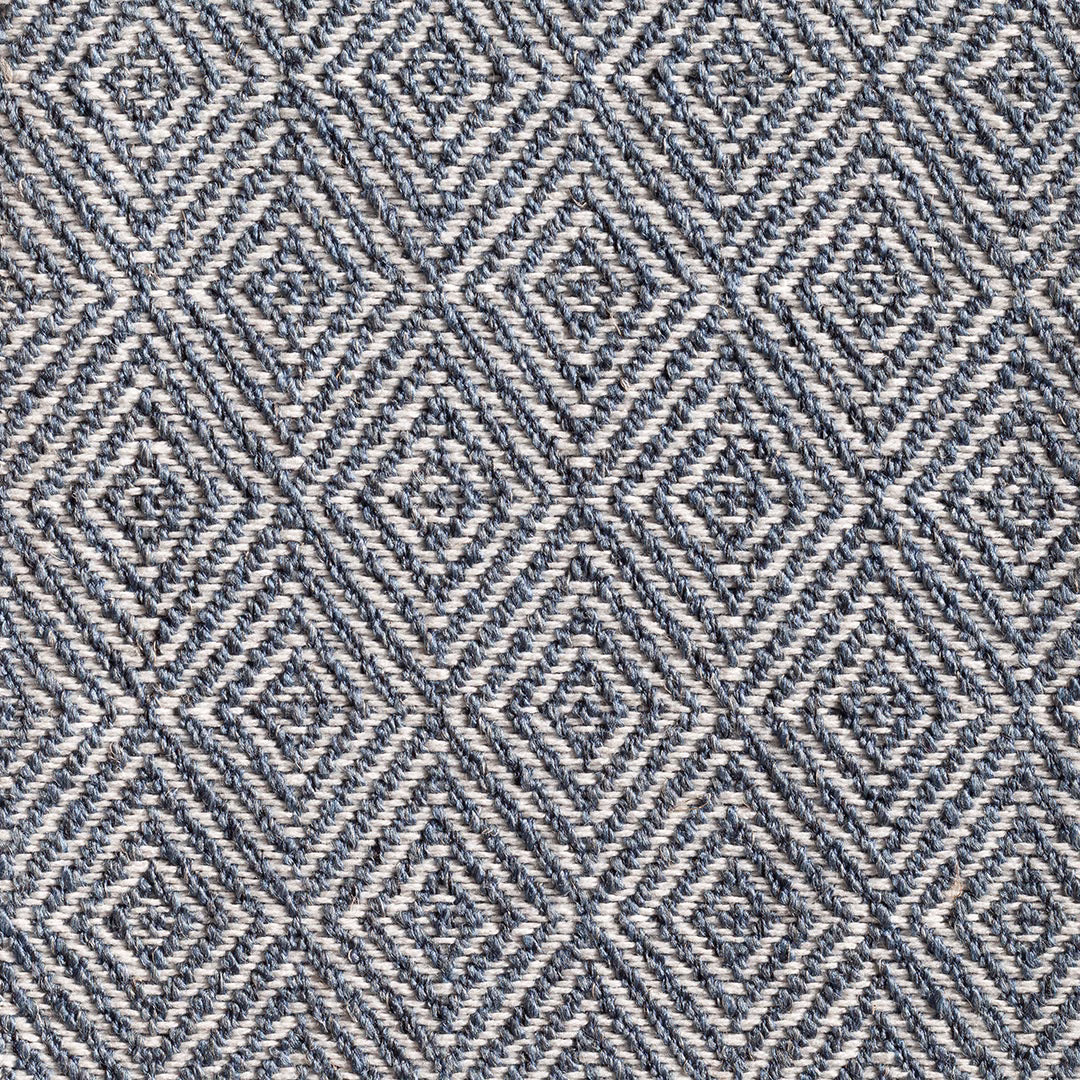 Ink-blue and cream woven fabric with tactile interlocking diamond motifs