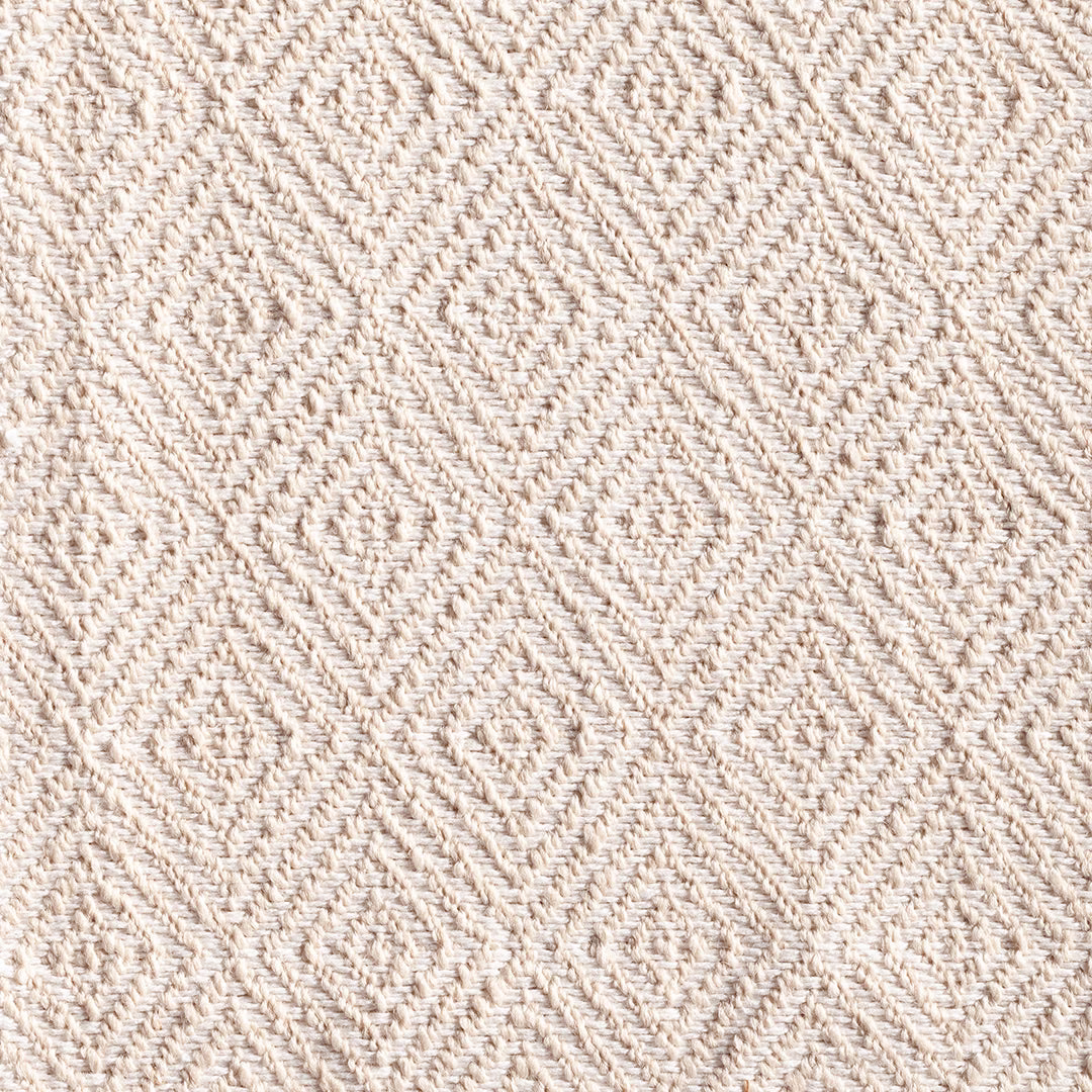 Warm ivory woven fabric with raised diamond and chevron texture