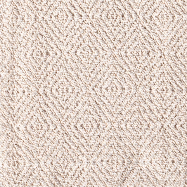 Warm ivory woven fabric with raised diamond and chevron texture