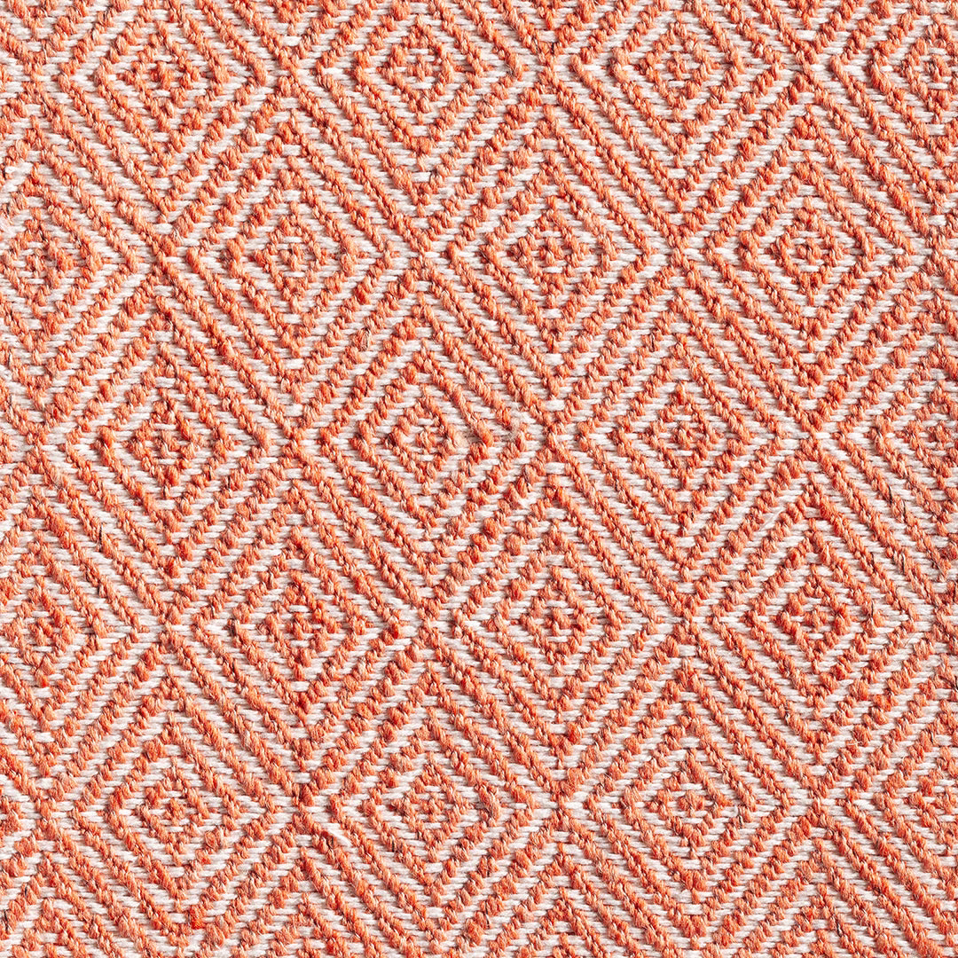 Pumpkin orange and cream woven fabric with raised repeating diamond motifs
