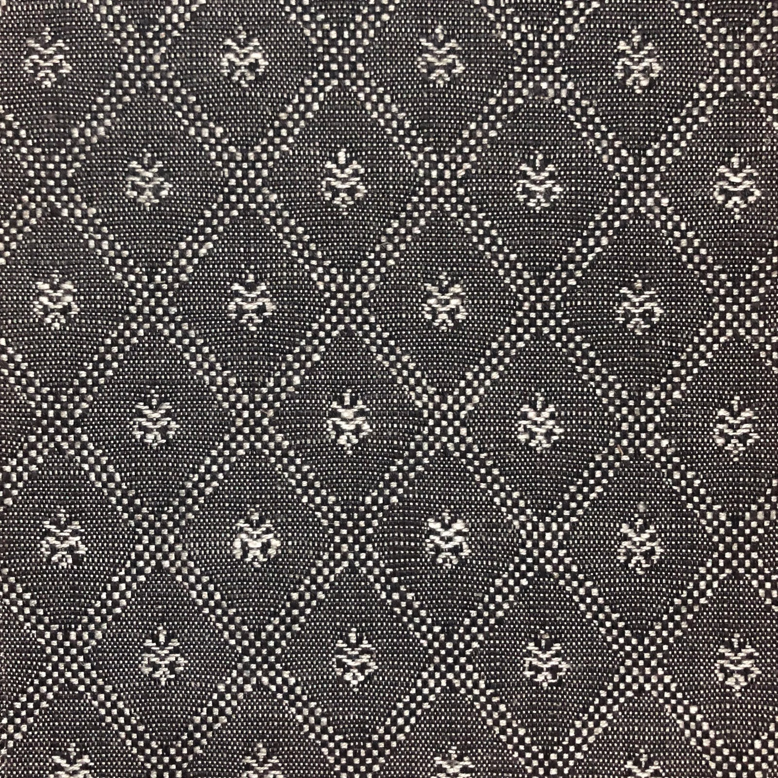 Charcoal woven fabric with ivory diamond trellis and small floral motifs