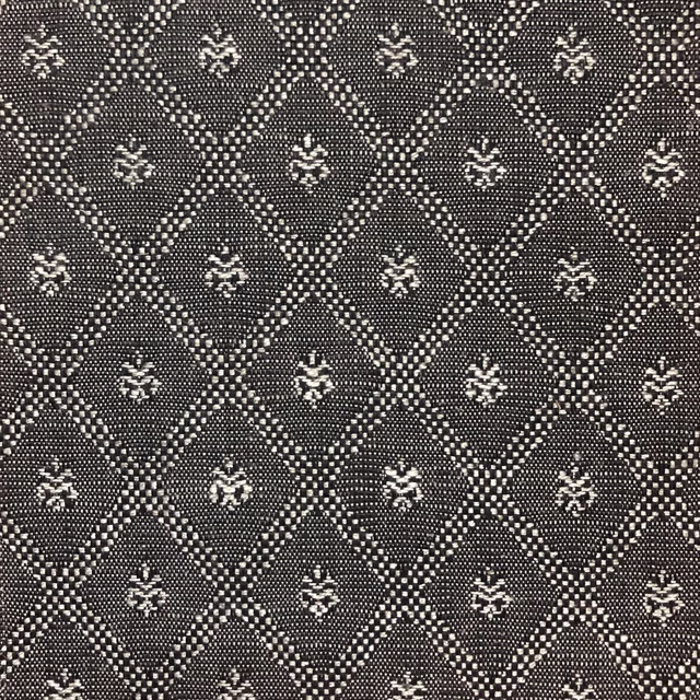 Charcoal woven fabric with ivory diamond trellis and small floral motifs