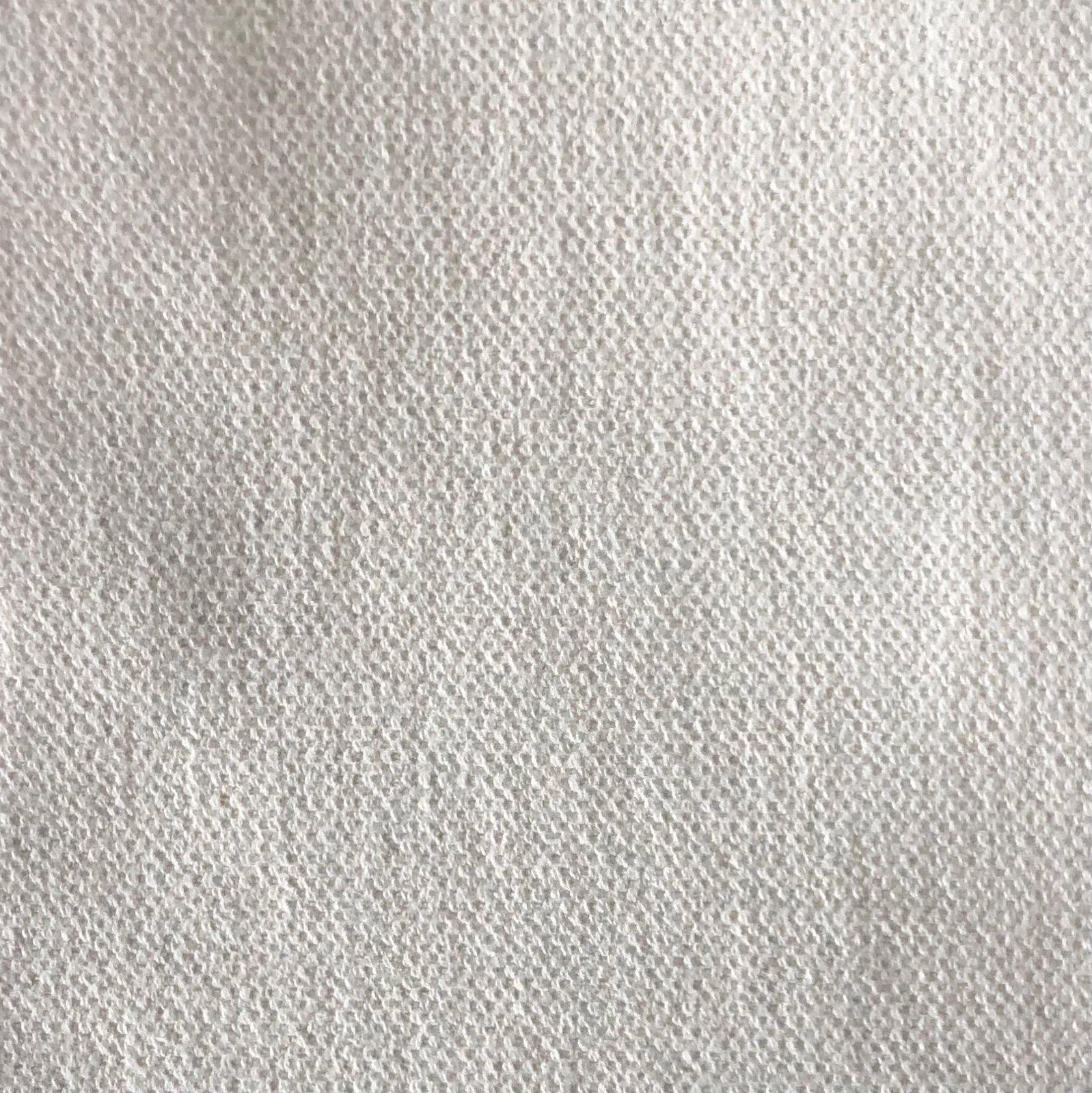 Pale greige textile showing a fine, softly mottled woven texture