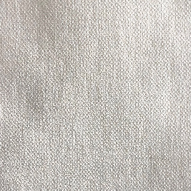 Pale greige textile showing a fine, softly mottled woven texture