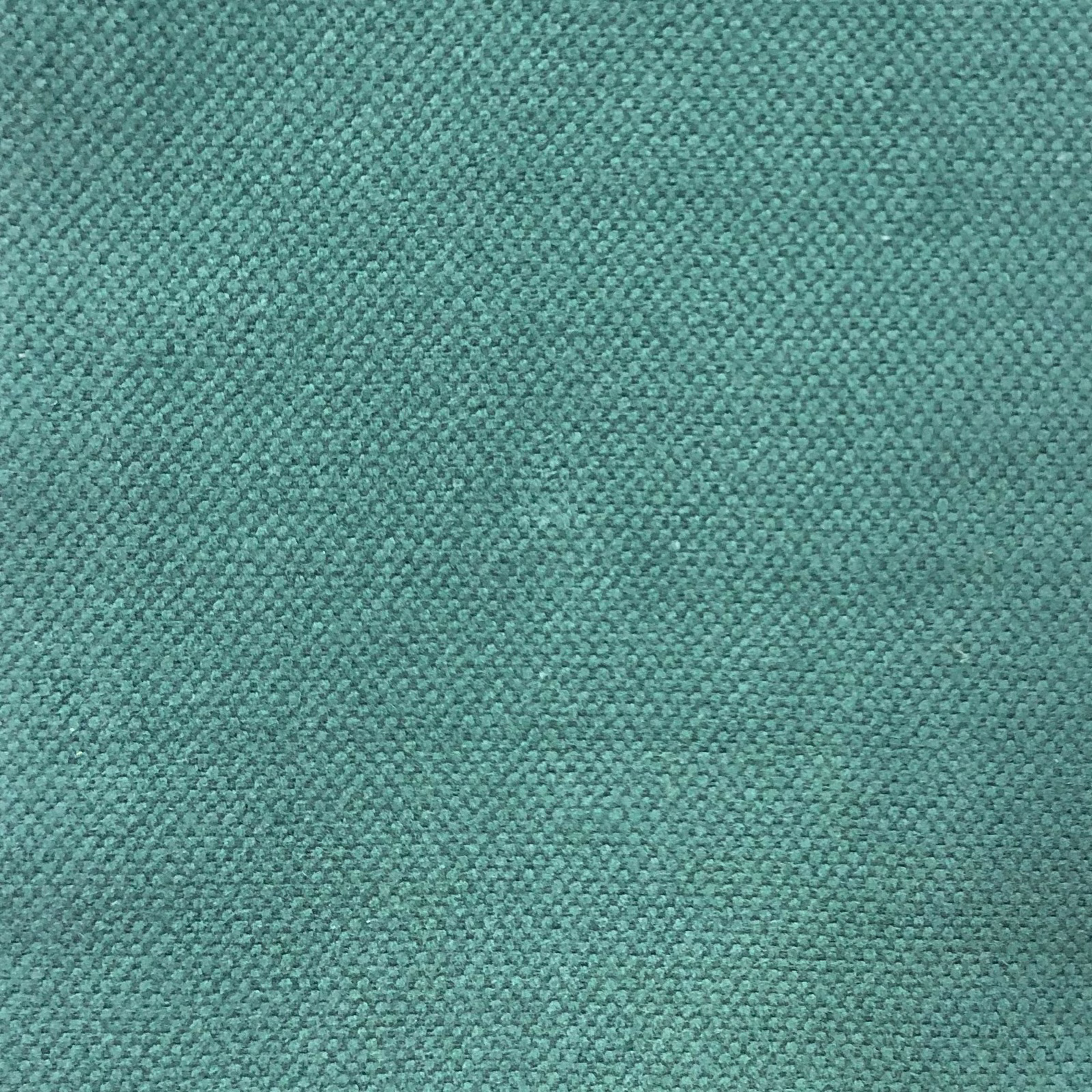 Close-up of muted teal woven fabric with a fine, softly mottled texture