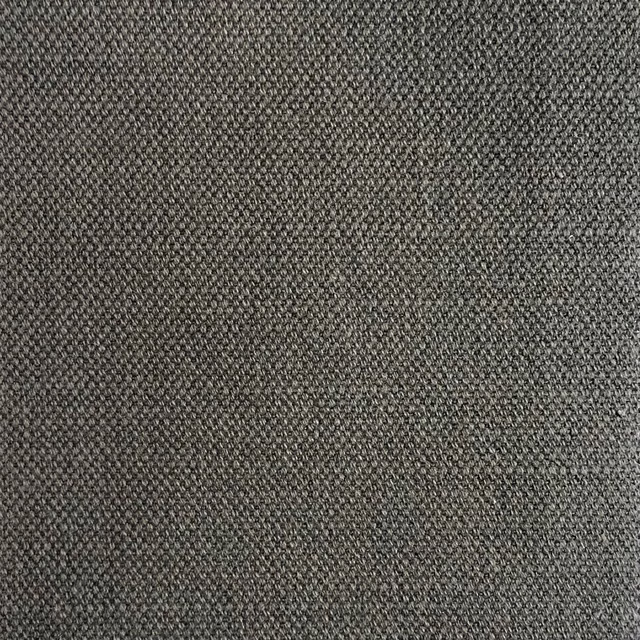 Close view of charcoal-grey woven fabric with fine peppered texture and lighter flecks