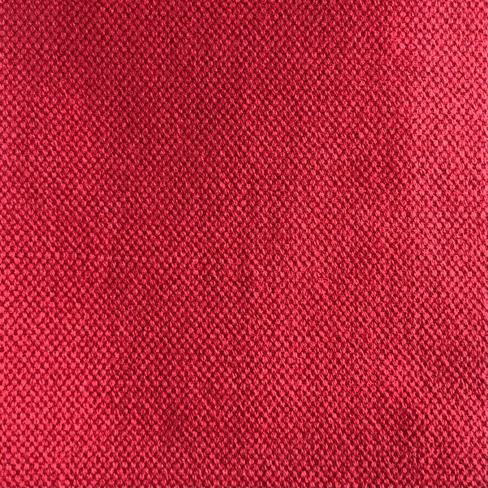 Close view of Duo 202's saturated raspberry-red, finely pebbled woven surface