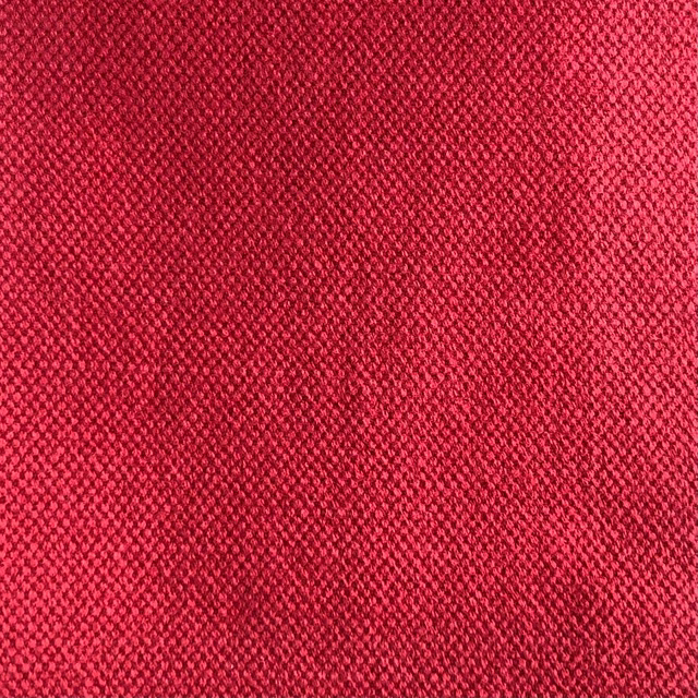Close view of Duo 202's saturated raspberry-red, finely pebbled woven surface