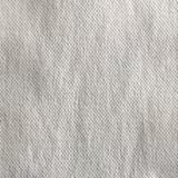 Close-up of pale ivory-grey fabric with a softly irregular nubby woven texture