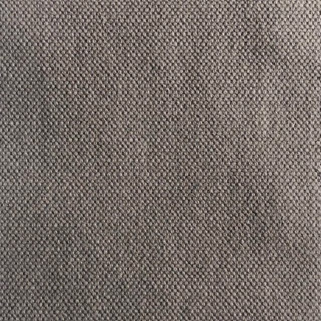 Warm taupe-grey fabric with a dense, softly pebbled woven texture