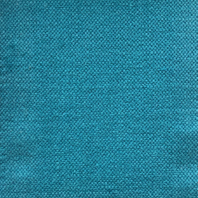 Close-up of deep blue teal fabric with a dense, pebbled woven texture