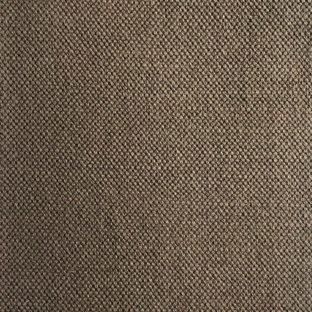 Close-up of warm taupe-brown fabric with a dense, finely textured woven surface