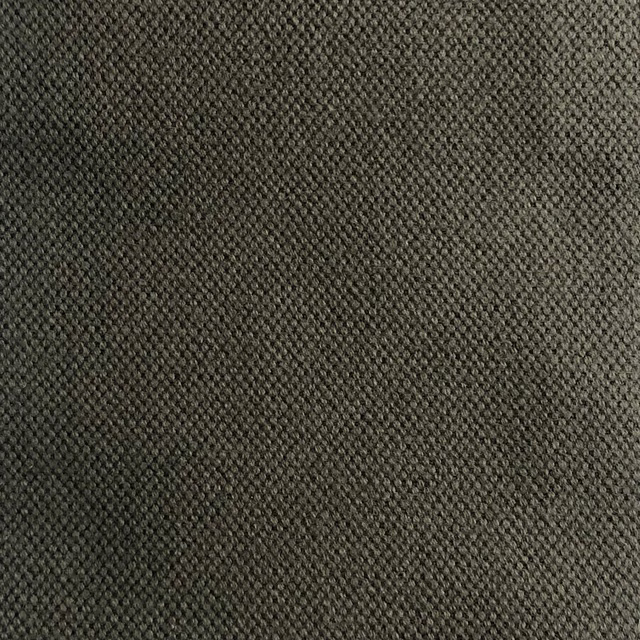 Close-up of charcoal olive-grey fabric with a dense, pebbled woven texture