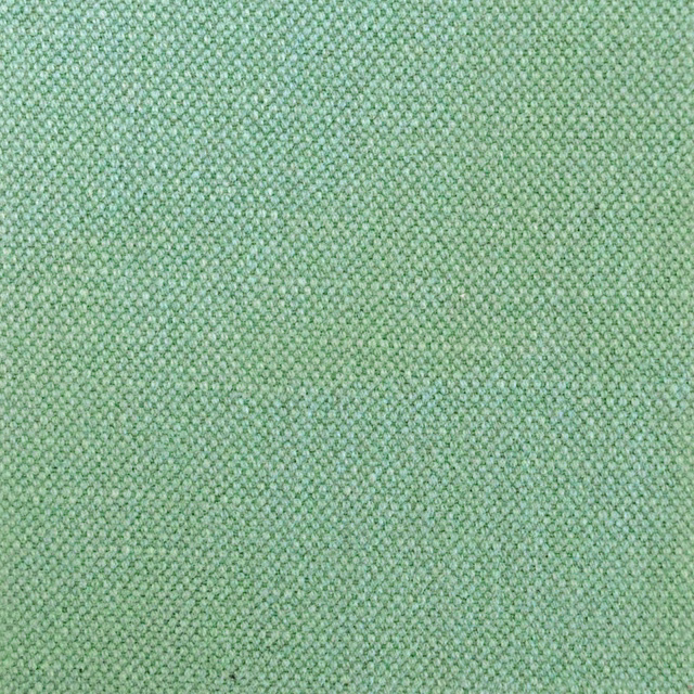 Close-up of soft mint-green fabric with a dense, finely nubby woven texture