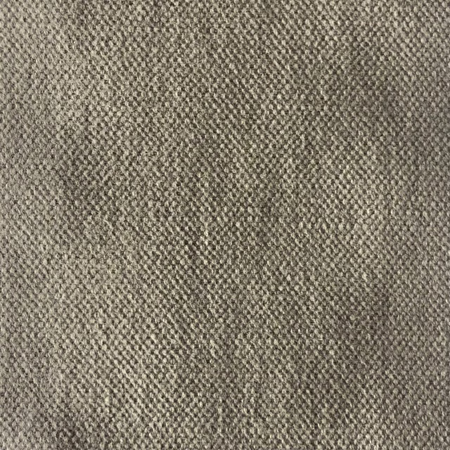 Close-up of muted taupe-grey fabric with dense, mottled woven texture