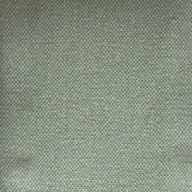Close-up of muted sage-grey fabric with a dense, finely pebbled woven texture