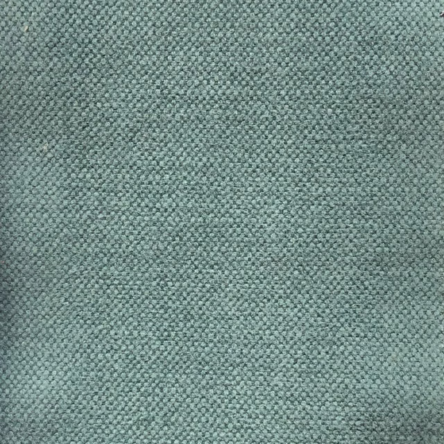 Close-up of muted teal-blue fabric with a dense, softly pebbled woven texture