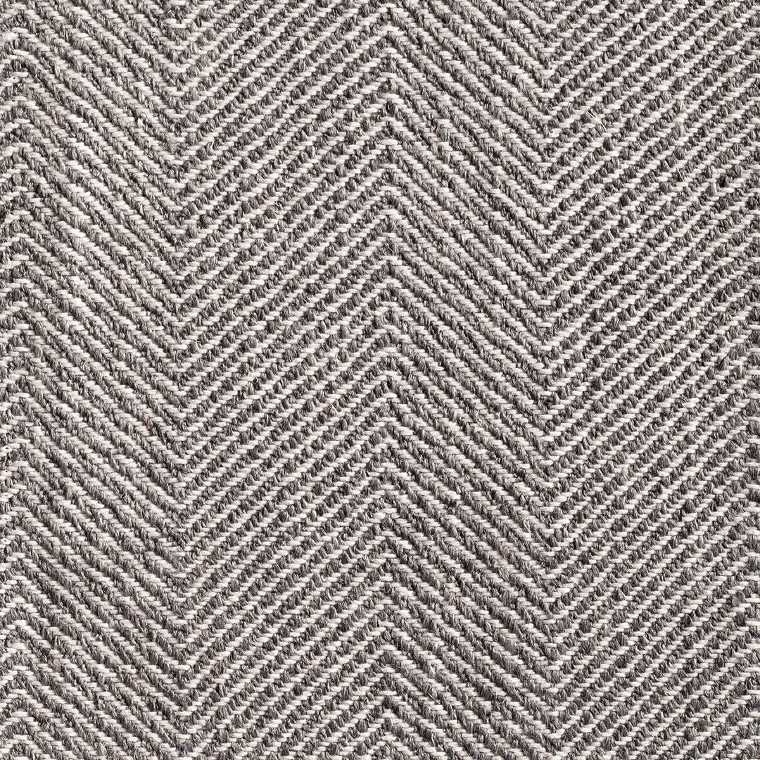 Close-up of Galdana Grey’s charcoal and ivory chevron weave with tactile texture