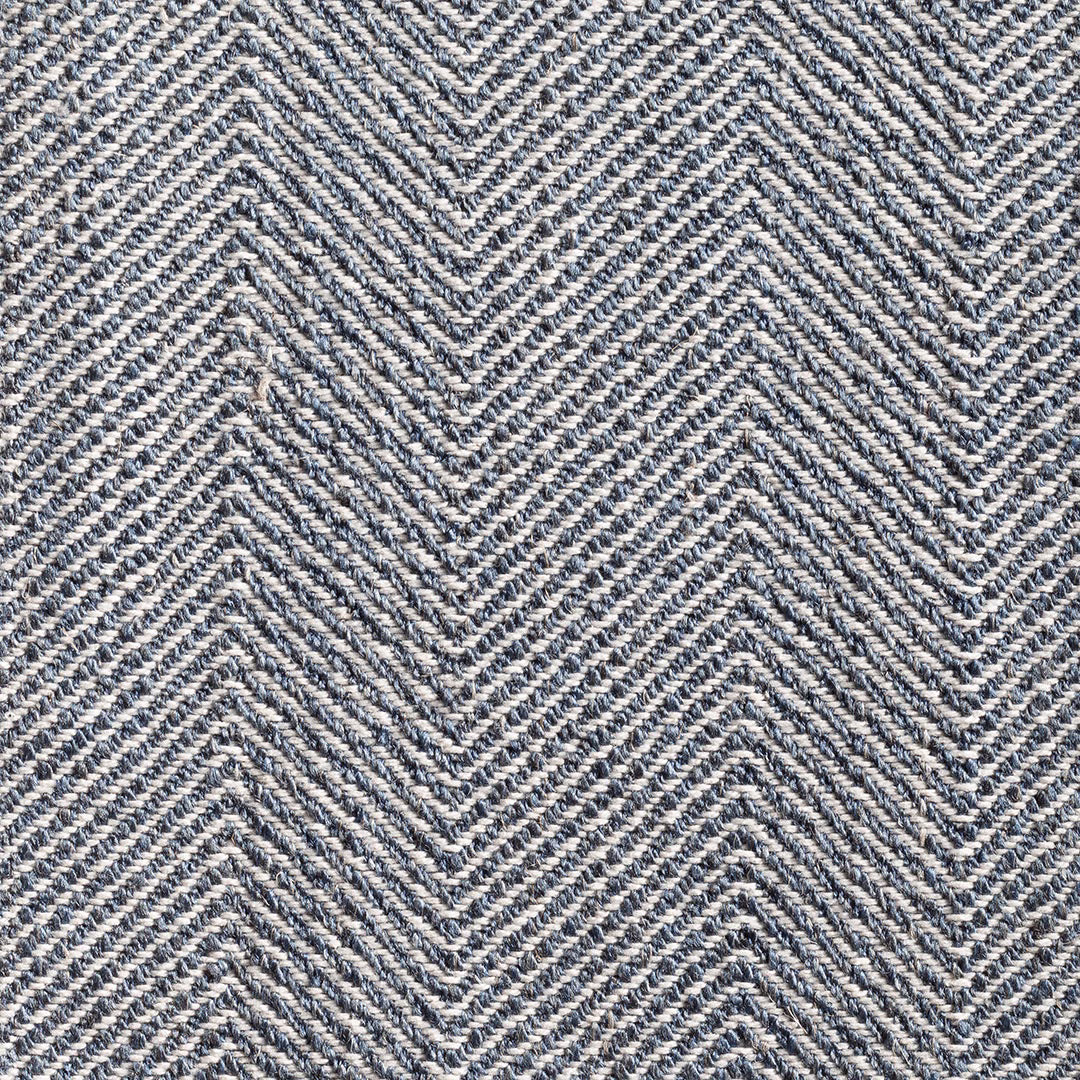 Close-up of ink-blue and ivory woven herringbone with tactile diagonal texture