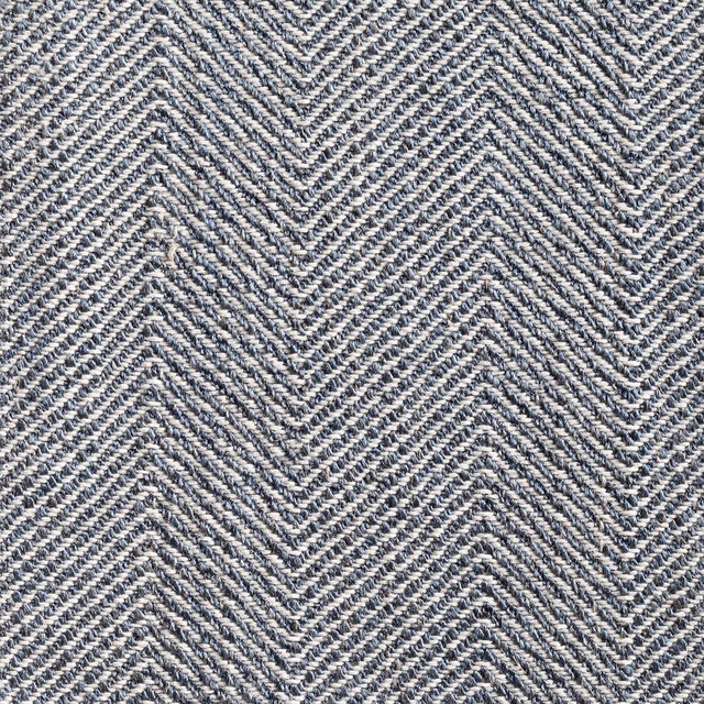 Close-up of ink-blue and ivory woven herringbone with tactile diagonal texture