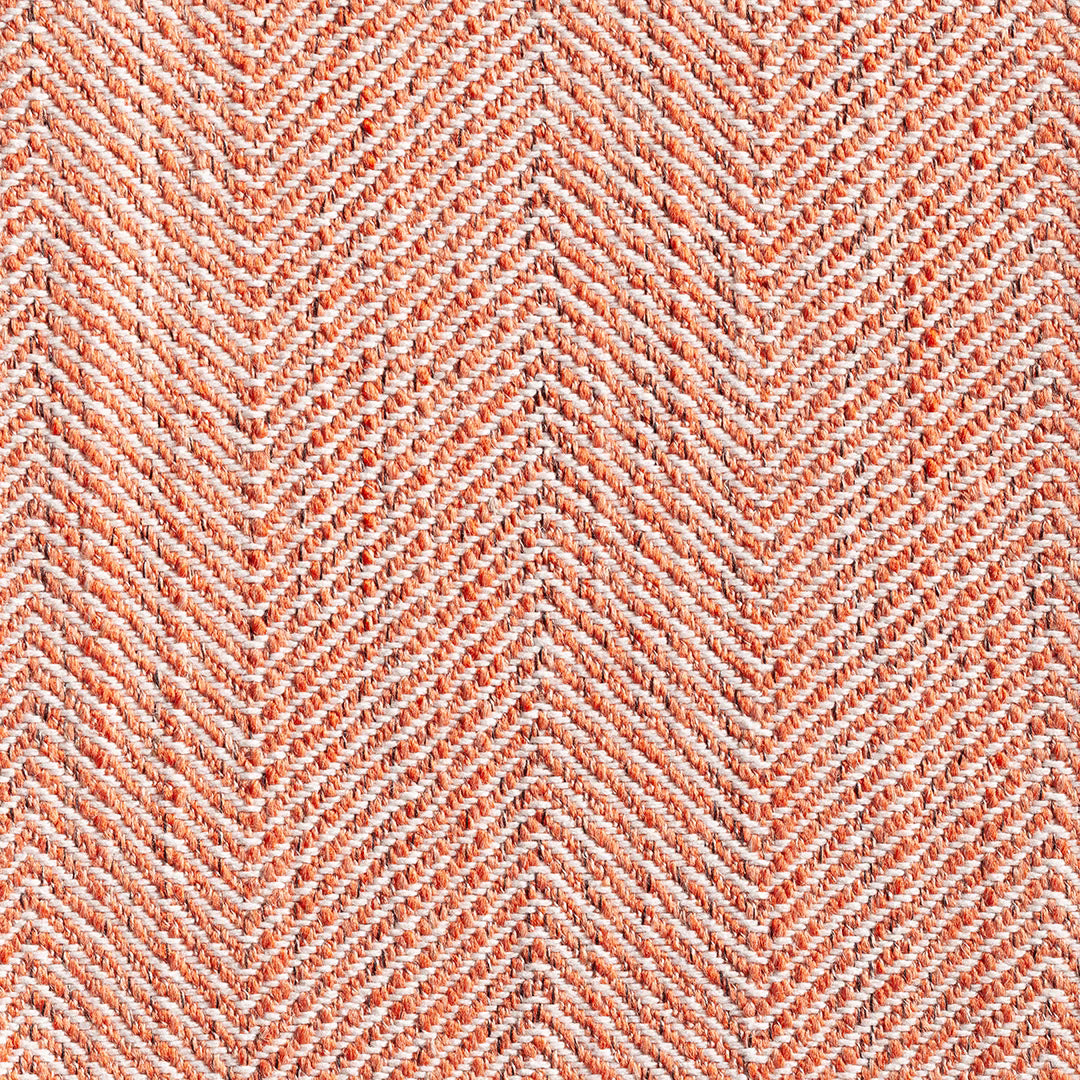 Warm pumpkin and ivory woven chevrons in a tactile herringbone close-up