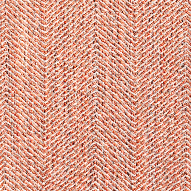 Warm pumpkin and ivory woven chevrons in a tactile herringbone close-up