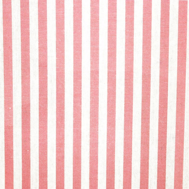 Muted coral pink and ivory vertical stripe fabric with a fine woven texture