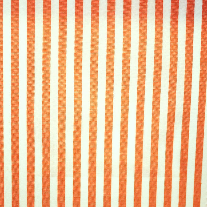 Burnt-orange and ivory vertical stripes in a fine, lightly textured weave