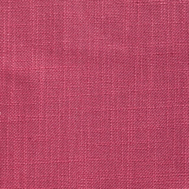 Close-up of tightly woven deep berry-pink textile with subtle tonal flecks
