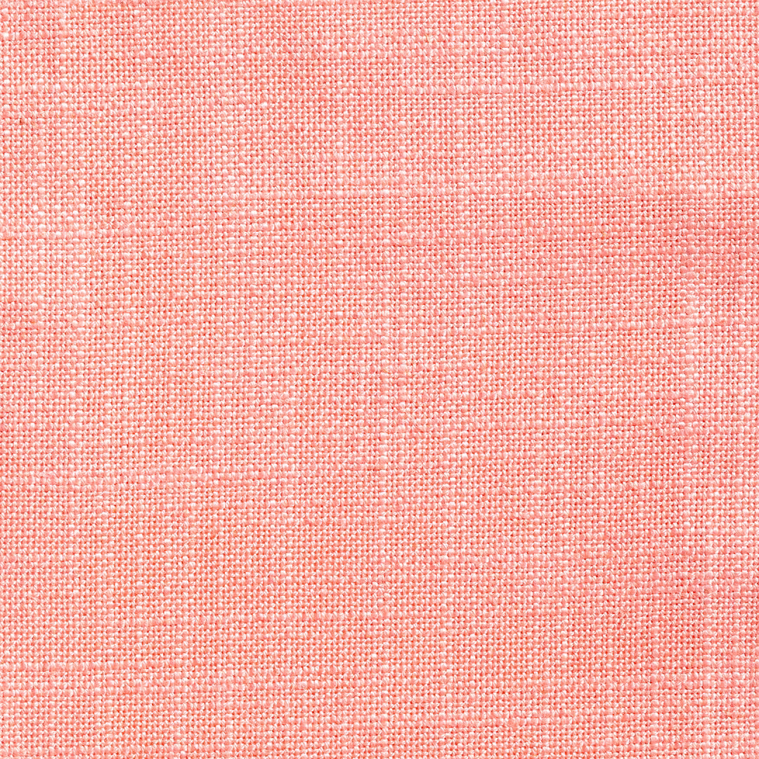 Close-up of soft coral-pink fabric with a fine pale flecked plain weave