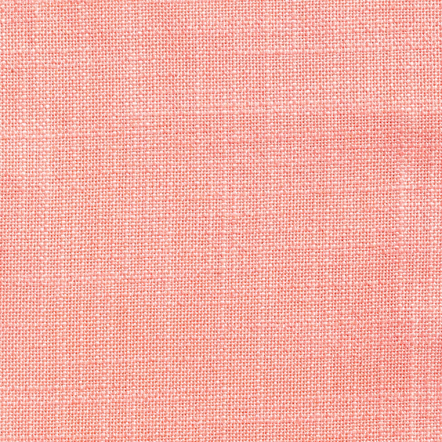 Close-up of soft coral-pink fabric with a fine pale flecked plain weave