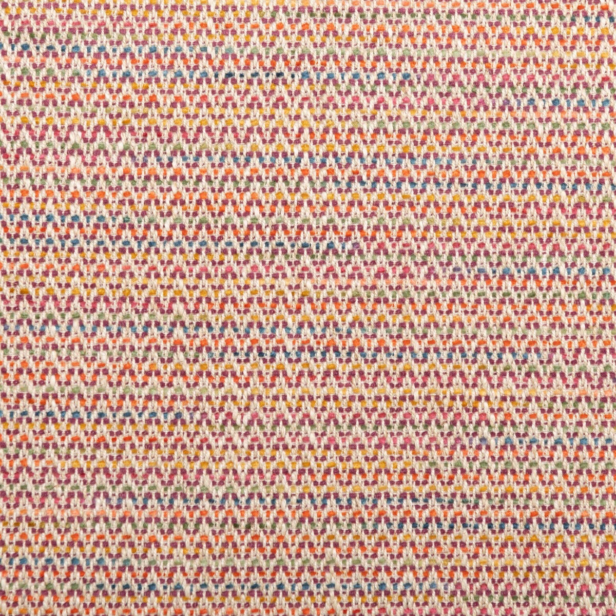 Close-up of rhubarb red woven fabric with tiny multicoloured geometric rows
