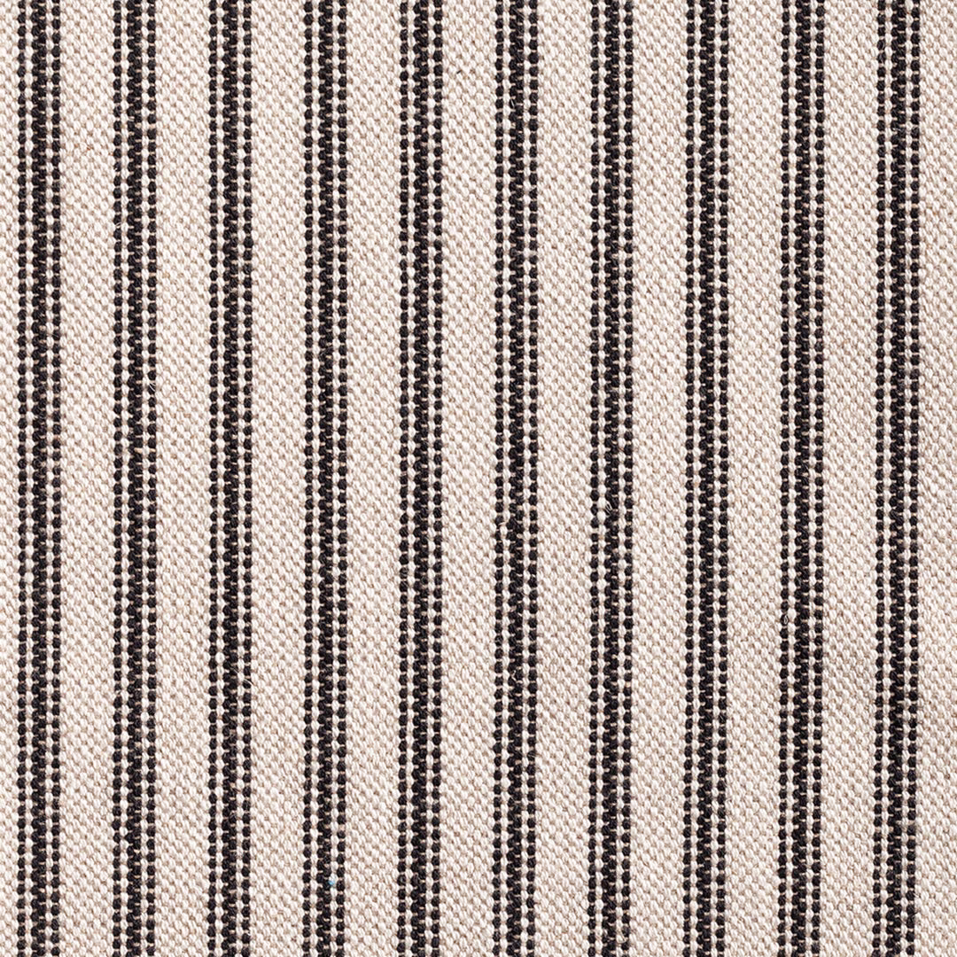 Close-up of black dotted vertical stripes woven through a warm cream ground