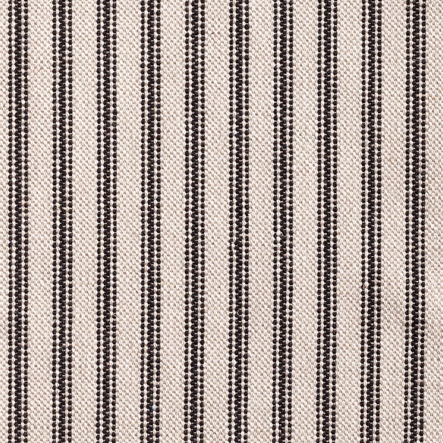 Close-up of black dotted vertical stripes woven through a warm cream ground