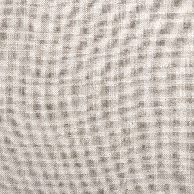 Close-up of warm oatmeal fabric with a fine, softly flecked woven grid